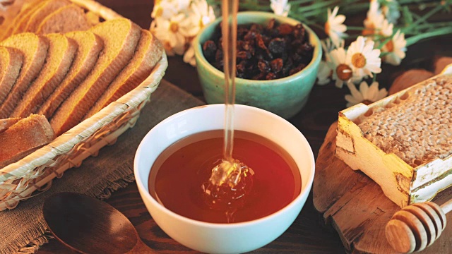 詳情圖-蜂蜜倒進(jìn)簡(jiǎn)陋的廚房桌子上的碗里